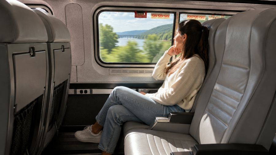 Passenger seated by the window in Amtrak Northeast Regional Coach Class